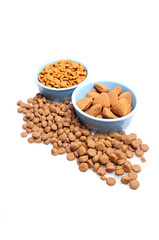 Blue ceramic dogs bowls. Dry dog food in bowl isolated on white background. Dry dog food isolated on white background