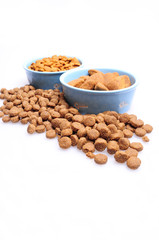 Blue ceramic dogs bowls. Dry dog food in bowl isolated on white background. Dry dog food isolated on white background