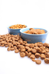 Blue ceramic dogs bowls. Dry dog food in bowl isolated on white background. Dry dog food isolated on white background