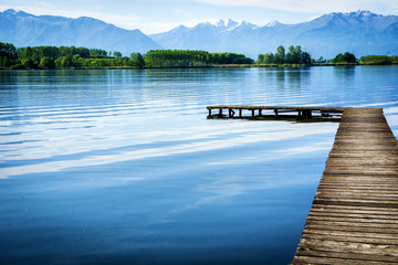 Wooden small pier over peaceful lake