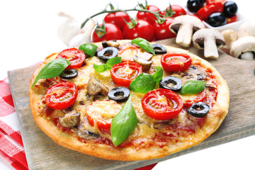 Tasty pizza with vegetables and basil close up