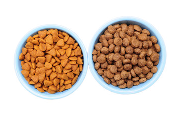 Blue ceramic dogs bowl. Dry dog food in bowl isolated on white background.