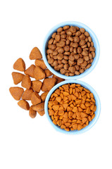 Blue ceramic dogs bowl. Dry dog food in bowl isolated on white background.