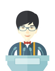 Chinese speaker stand behind a podium.