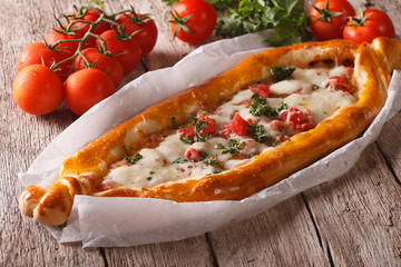 Turkish Pizza and ingredients close-up on a table. horizontal
