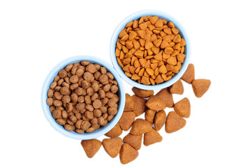 Blue ceramic dogs bowl. Dry dog food in bowl isolated on white background.