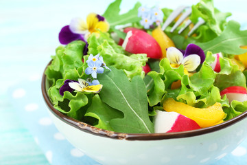 Light organic salad with flowers, close up