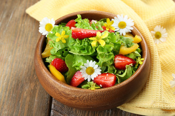 Light organic salad with flowers, close up