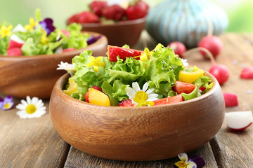 Light organic salad with flowers, close up