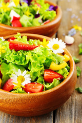 Light organic salad with flowers, close up