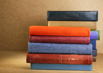 Old books on shelf, close-up, on wooden background