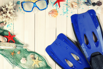 Sea composition with flippers and shells on wooden table close up © Africa Studio