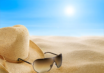 Beach Day straw hat and sunglasses on a beach
