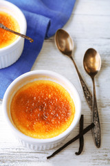 Creme brulee dessert  on napkin, on color wooden background