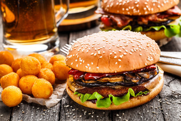 Delicious burger with fried potato balls and beer