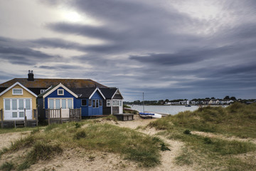 Fototapeta na wymiar Lovely beach huts on sand dunes and beach landscape