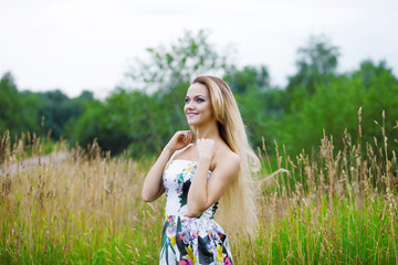   blond girl in dress  on a meadow