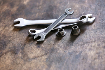 Wrenches and bolts on table close up