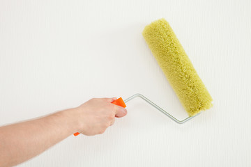 Male hand holding a roller