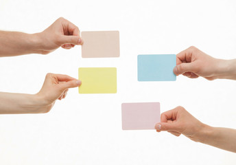 Obraz premium Human hands holding colorful paper cards