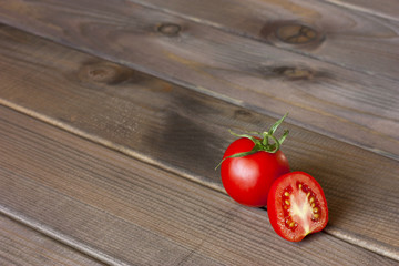 Fresh tomatoes on the dark wooden table