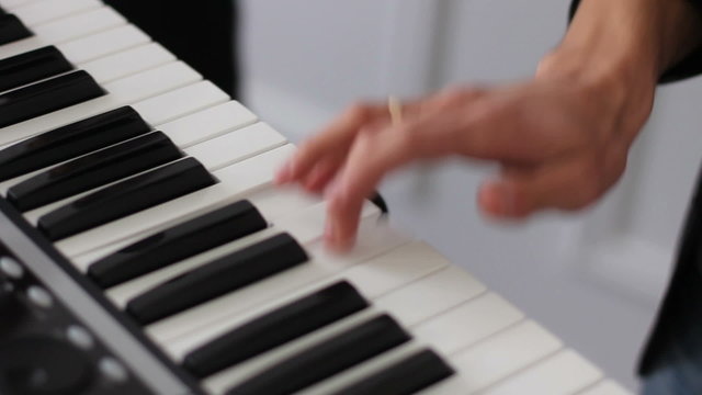 young skilled man plays piano