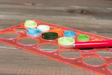 Bright colored background items for quilling (paper, ruler)