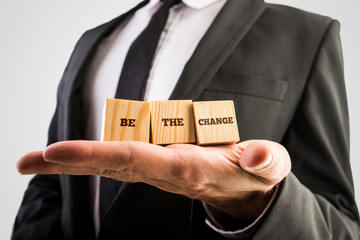 Closuep of a professional adviser holding three wooden cubes in