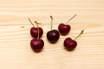Five cherry placed on the wood
