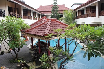 Fototapeta na wymiar Inside the Flora Kuta Hotel in Bali, view of the swimming pool from the room