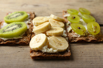 Tasty vegetarian sandwiches on wooden table