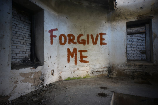 text forgive me on the dirty old wall in an abandoned ruined house