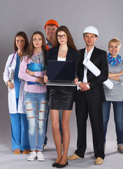 Smiling businesswoman with laptop  and group of industrial