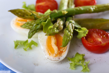 Plate of dietary salad with boiled asparagus and egg, closeup