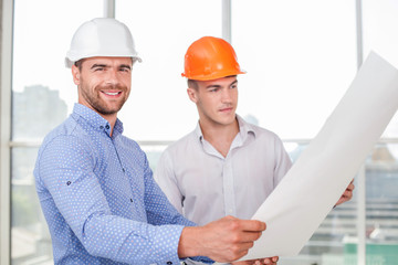 Attractive young builders are working on a new project