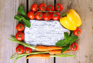 Fresh vegetables on wooden table, top view