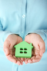 Female hands holding house, closeup