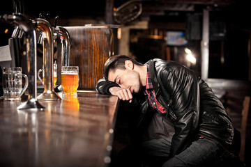 was a hard day. Depressed  man drinking beer in bar 