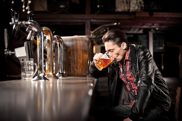was a hard day. Depressed  man drinking beer in bar 