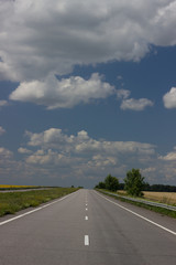 Fototapeta premium Asphalt road over blue sky background. 