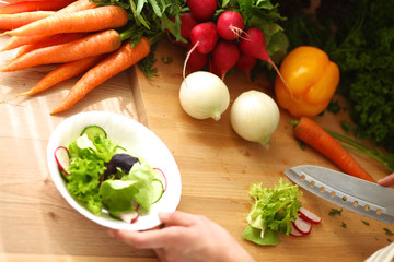 Young woman cutting vegetables in the kitchen
