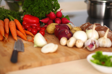 Young woman cutting vegetables in the kitchen