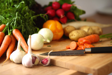 Young woman cutting vegetables in the kitchen