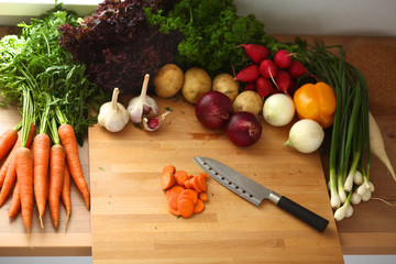 Young woman cutting vegetables in the kitchen
