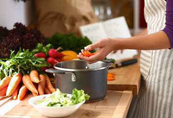 Young woman cutting vegetables in the kitchen