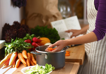 Young woman cutting vegetables in the kitchen