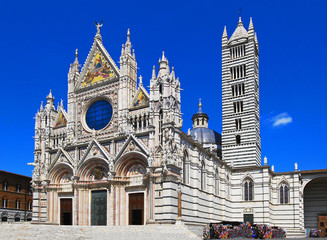 SIENA, ITALY - CIRCA AUGUST 2009 - The magnificently decorated Duomo of Siena, with its black and white striped marble bell tower - obrazy, fototapety, plakaty