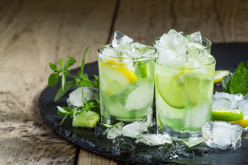 Lemon-lime green drink with crushed ice on a dark background, se