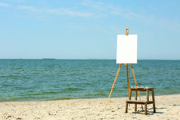 Easel with canvas on beach