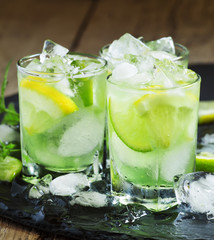 Lemon-lime green drink with crushed ice on a dark background, se